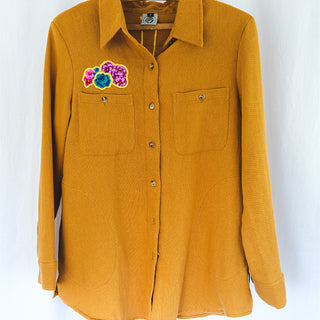 Marigold color button down blouse with sun moon collage on the back in vintage Hawaiian barkcloth
