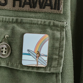 wings hawaii rainbow surfer girl enamel pin shown on jacket