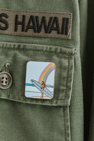 wings hawaii rainbow surfer girl enamel pin shown on jacket
