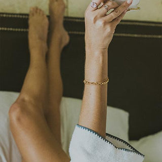 Model wearing Wings Hawaii Chain Reaction Bracelet in gold fill