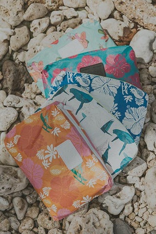 A collection of Wings Hawaii foldable adventure pouches