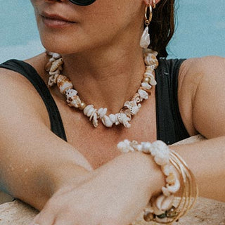 model wearing Wings Hawaii shell pile necklace and bracelet