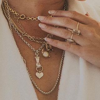 Model wearing Wings Hawaii Stolen Heart Necklace, shown layered with others