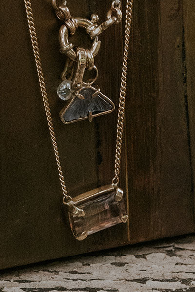 A lovely emerald-cut pink Sunstone, prong set on solid 14 karat yellow gold.