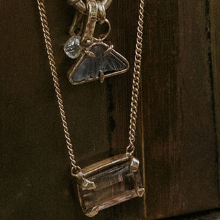 A lovely emerald-cut pink Sunstone, prong set on solid 14 karat yellow gold.