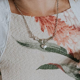 Model wearing Wings Hawaii Stolen Heart Necklace in sterling silver