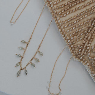 A delicate chain necklace with 9 raw diamonds