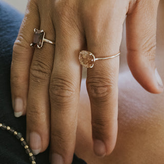 A Pink Oval Cut sunstone prong set on a 14K Yellow Gold Ring