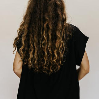 Wings Hawaii model wearing Classic Black Boxy Button-up - back 