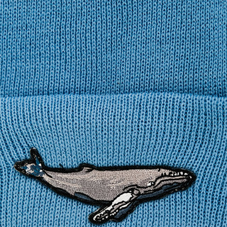 light blue fold over beanie with humpback whale patch