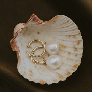 Large baroque freshwater pearls set on 14K yellow gold closing hoop earrings