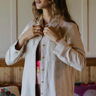 Button down blouse in bone color with sun moon collage patch on the back