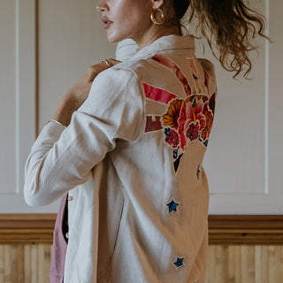 Button down blouse in bone color with sun moon collage patch on the back