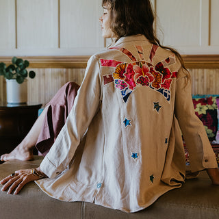 Button down blouse in bone color with sun moon collage patch on the back