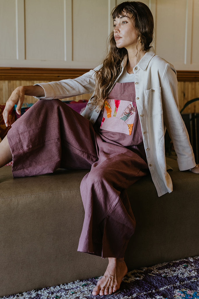 Linen rose colored wide leg overalls with collage sun patch as front pocket