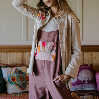 Linen rose colored wide leg overalls with collage sun patch as front pocket
