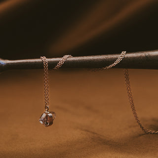 Banded herkimer dangling on a delicate chain necklace