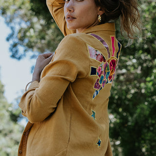 Marigold color button down blouse with sun moon collage on the back in vintage Hawaiian barkcloth