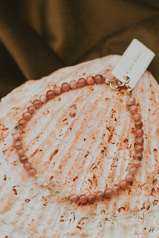 Beaded bracelet with rhodochrosite beads and herkimer beads with 14k plated over sterling silver spacers