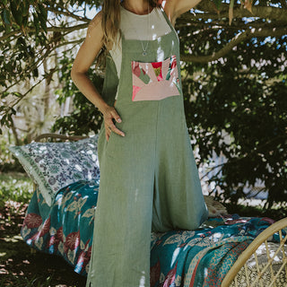 Linen sage colored wide leg overalls with pink sun collage patch as front pocket