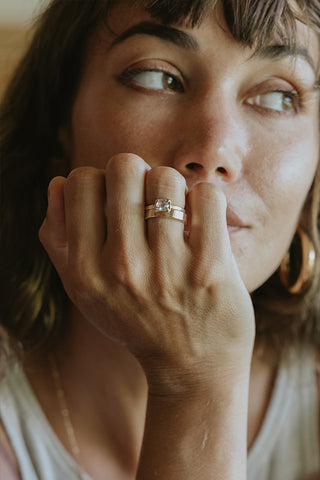 A Raw Diamond Prong Set on a 14K Yellow Gold Band