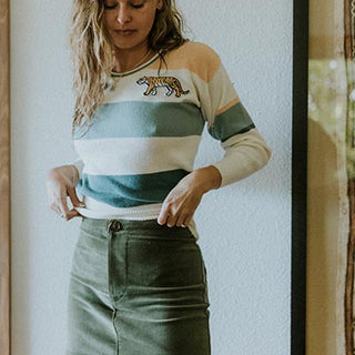 Wings Hawaii model wearing the vintage tiger sweatshirt and corduroy skirt