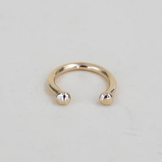 A Womens ring in the shape of a horse shoe