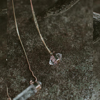 Banded herkimer dangling on a delicate chain necklace