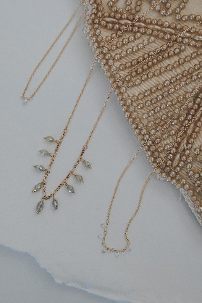 A delicate chain necklace with 9 raw diamonds