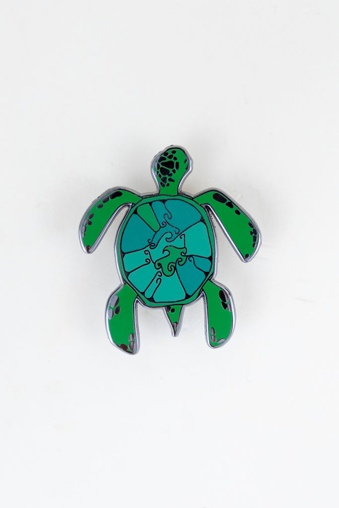enameled pin of a green sea turtle